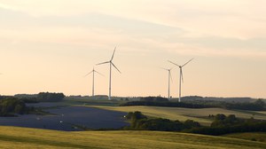 Foto: Windräder und Photovoltaikanlage vor einer Landschaft 