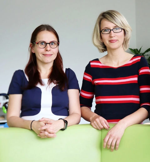 Foto von zwei Frauen, die in die Kamera schauen.