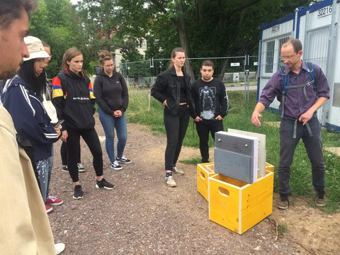 Gruppe von Studierenden und einem Modell der Bauweise des CUBE Carbonbetongebäudes