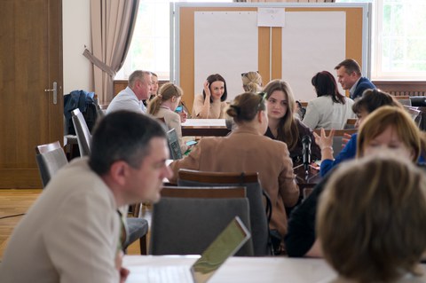 Participants of the working groups sit at tables