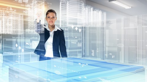 Eine Frau steht vor einem Tisch über dem Hologramme von Gebäuden sichtbar sind und dreht die Ansicht 