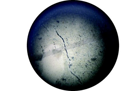 Small crack through a crack measuring magnifier