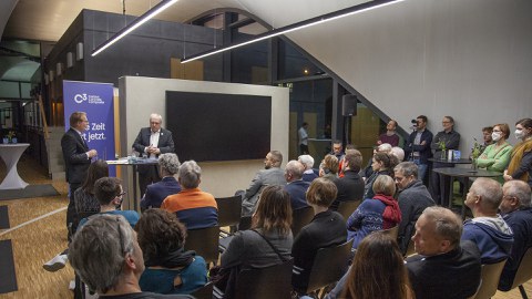 Foto zeigt das Carbonbetonhaus CUBE mit vielen Gästen zur Buchvorstellung