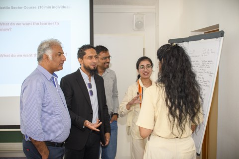 small group discussing in front of a flip-chart