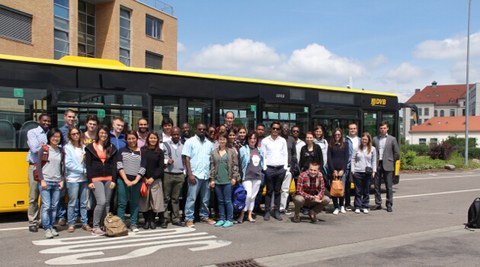 Course participants in front of a bus of the Dresden public transport enterprise (DVB)