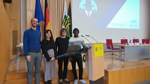 The four students at the lectern