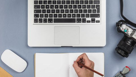 Person writing, Notebook on a Table