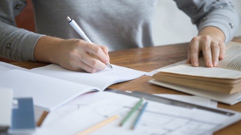 student female hands performing written task copybook