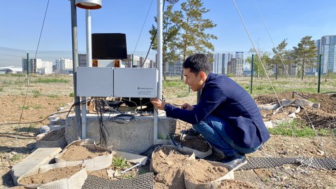 Nurlan Ongdas setting up the weather station at the research test field on the Nazarbayev University campus