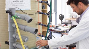 José takes measurements at the lab-aquifer tank