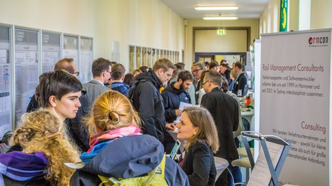 Many people standing and chatting in a hall