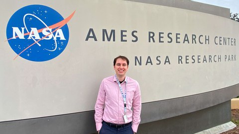 Kevin-Christian Garzon Galindo in front of the entrance to the NASA Ames Research Center 