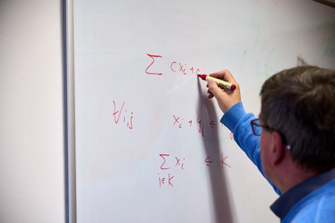 Karl Nachtigall schreibt an einem Whiteboard