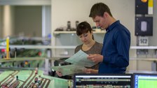 internship in the Railway Operations Laboratory, two students in front of the railroad system study the assignment