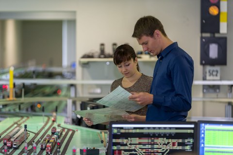 internship in the Railway Operations Laboratory, two students in front of the railroad system study the assignment