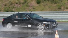 Car driving on wet road at Lausitzring