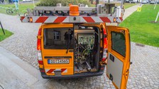 Measurement vehicle for recording the road space using front and rear cameras with path-dependent or time-dependent image triggering