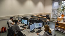 Group of students with computers during project work