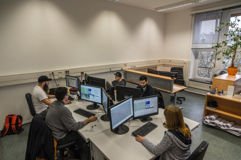 Group of students with computers during project work