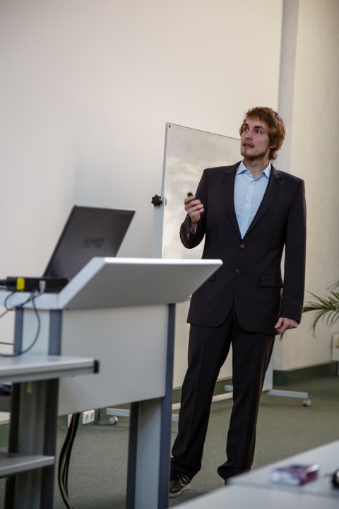 A man in a suit is giving a presentation.