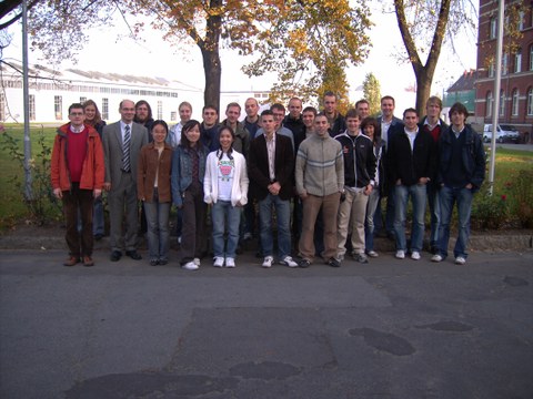 Group photo (24 persons) in nature.