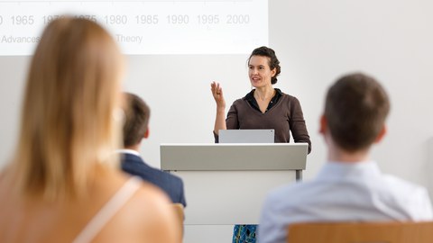 You can see a woman giving a speech