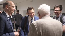 Es sind vier Gäste einer Festveranstaltung zu sehen, die sich unterhalten