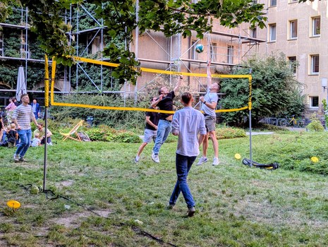 Zu sehen sind junge Menschen, die Volleyball spielen