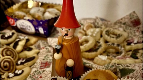 Ein Räuchermännchen umgeben von süßen Snacks