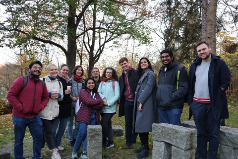 Photo: a group of 11 people standing outside smiling into the camera