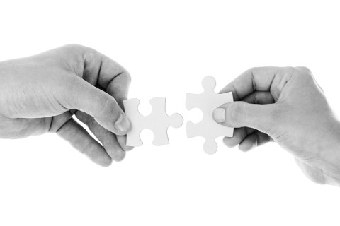 Cooperation/people holding puzzle pieces