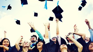 PhD students throwing up their huts to celebrate their graduation