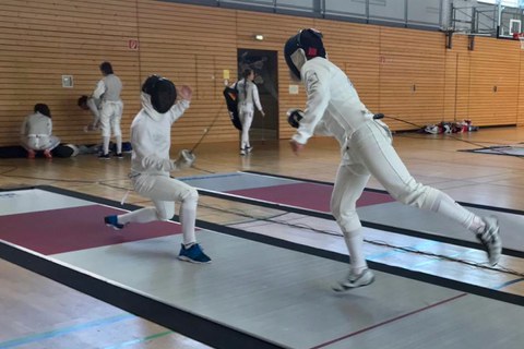 Foto zwei Fechter:innen im sportlichen Duell