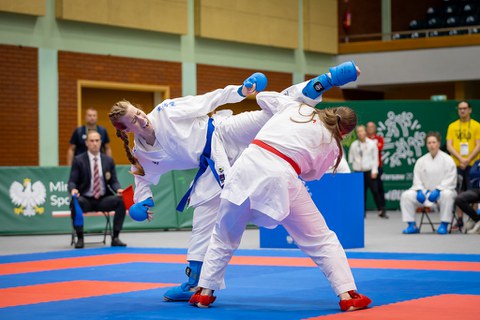 Foto: zwei Sportlerinnen im Karatanzug beim Wettkampf
