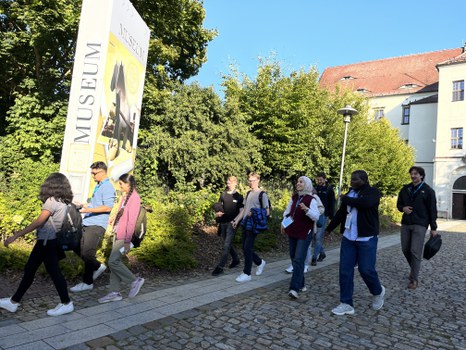 Participants run along the path in front of the castle