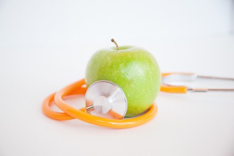 An apple and a sthetoscope.