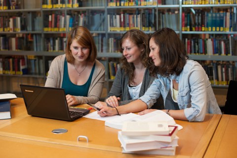 drei Doktorandinnen arbeiten in der Bibliothek