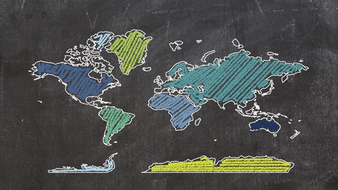 Board on which is drawn with chalk the outlines of the continents.