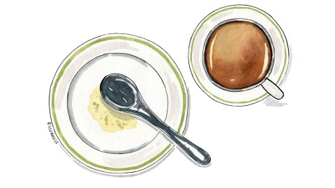 Ein Teller, auf dem ein Löffel liegt und eine Tasse Kaffee.
