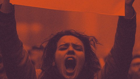 A person is holding a poster and screams. 