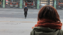 Personen betrachten sich über eine Straße hinweg