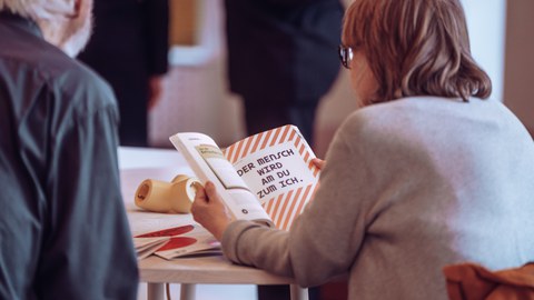Menschen blättern in Buch