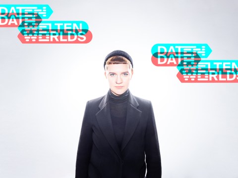 Photo of the artist with the text "Data Worlds"