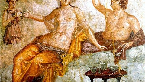 Wall painting depicting a banquet. A man drinks from a type of drinking vessel with two openings called a rhyton. His female companion wears a sheer garment and a golden net over her hair. A female servant attends to the couple, proffering a small box. The table in front holds a set of silver vessels for mixing wine. The whole scene represents an idealized Greek drinking party, a pleasurable sight for the guests of this first century Roman household. 