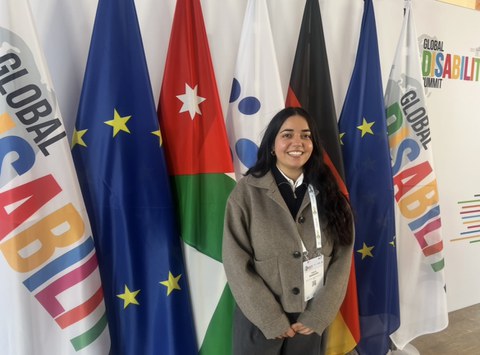 Scherin Wahabzadeh, vor Flaggen stehend