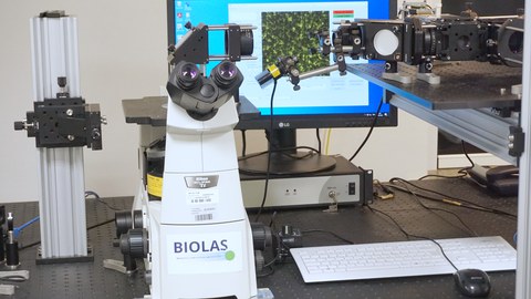 Optogenetic stimulation platform consisting of an inverted microscope body and custom adapticve stimulation optics