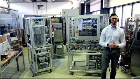 Screenshot of an online meeting with a man in front of technical equipment of the Safety Demonstrator