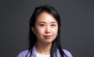 Smiling woman in front of a dark background