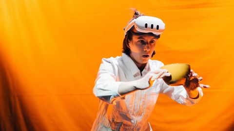 Photo from the theater act: Jeannie with XR-HMD moving surprised a cup.