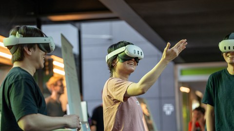 Three people using Multi-User Mixed Reality together.